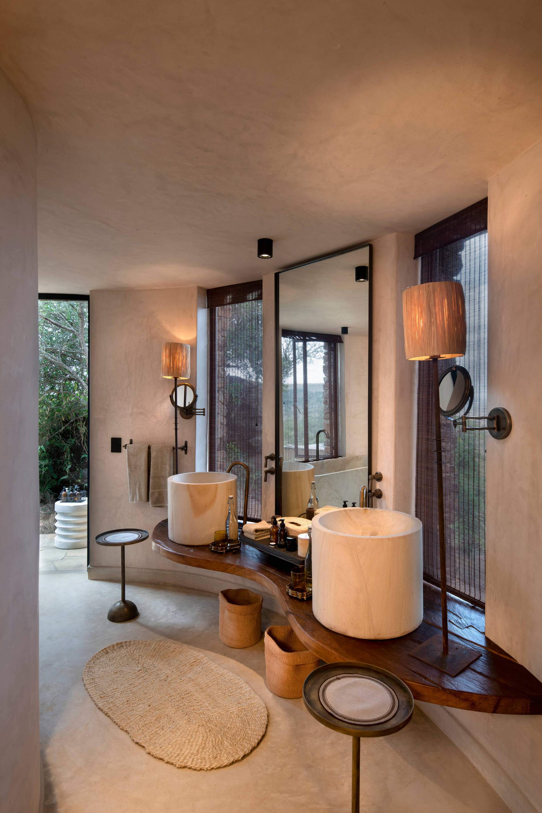 A bathroom with a large white bathtub and a mirror.