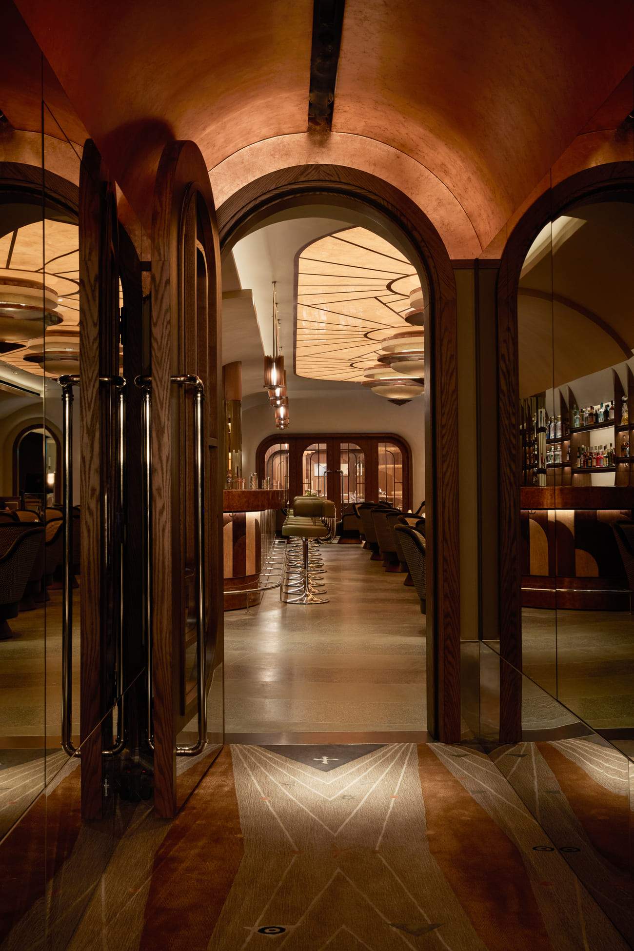 A bar with a large mirror and a wooden door.