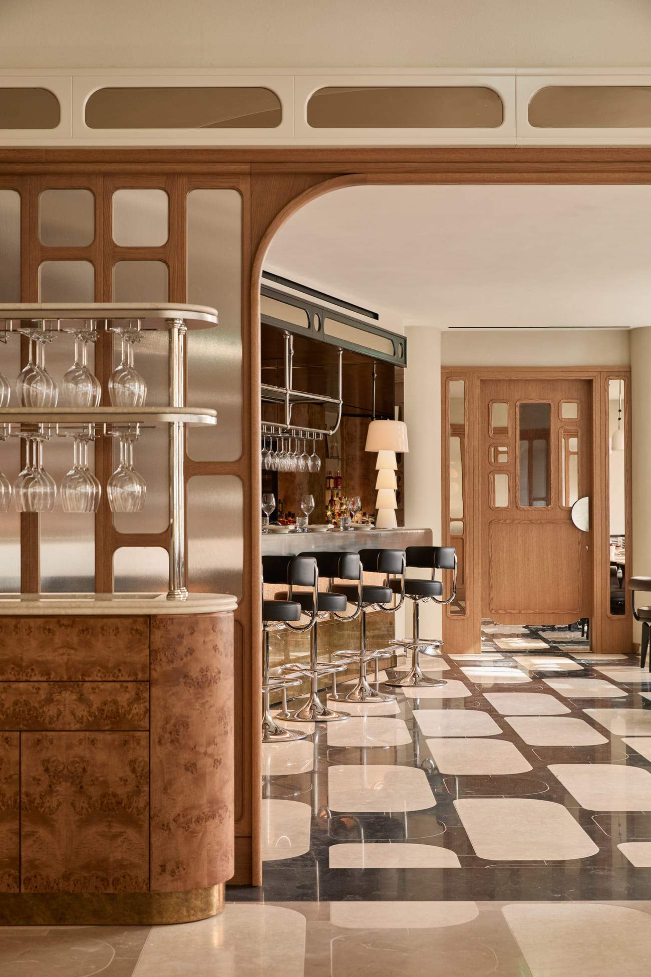 A bar with a wooden door and a mirror on the wall.