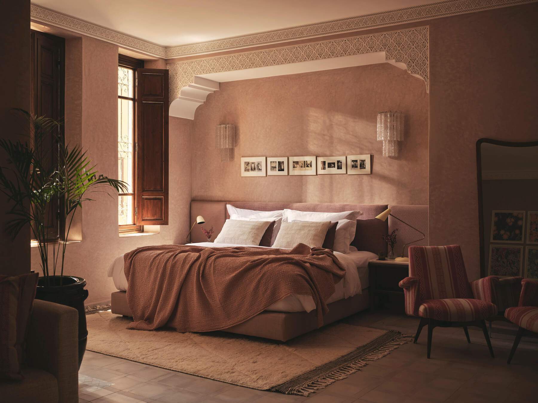A bedroom with a bed and a chair.