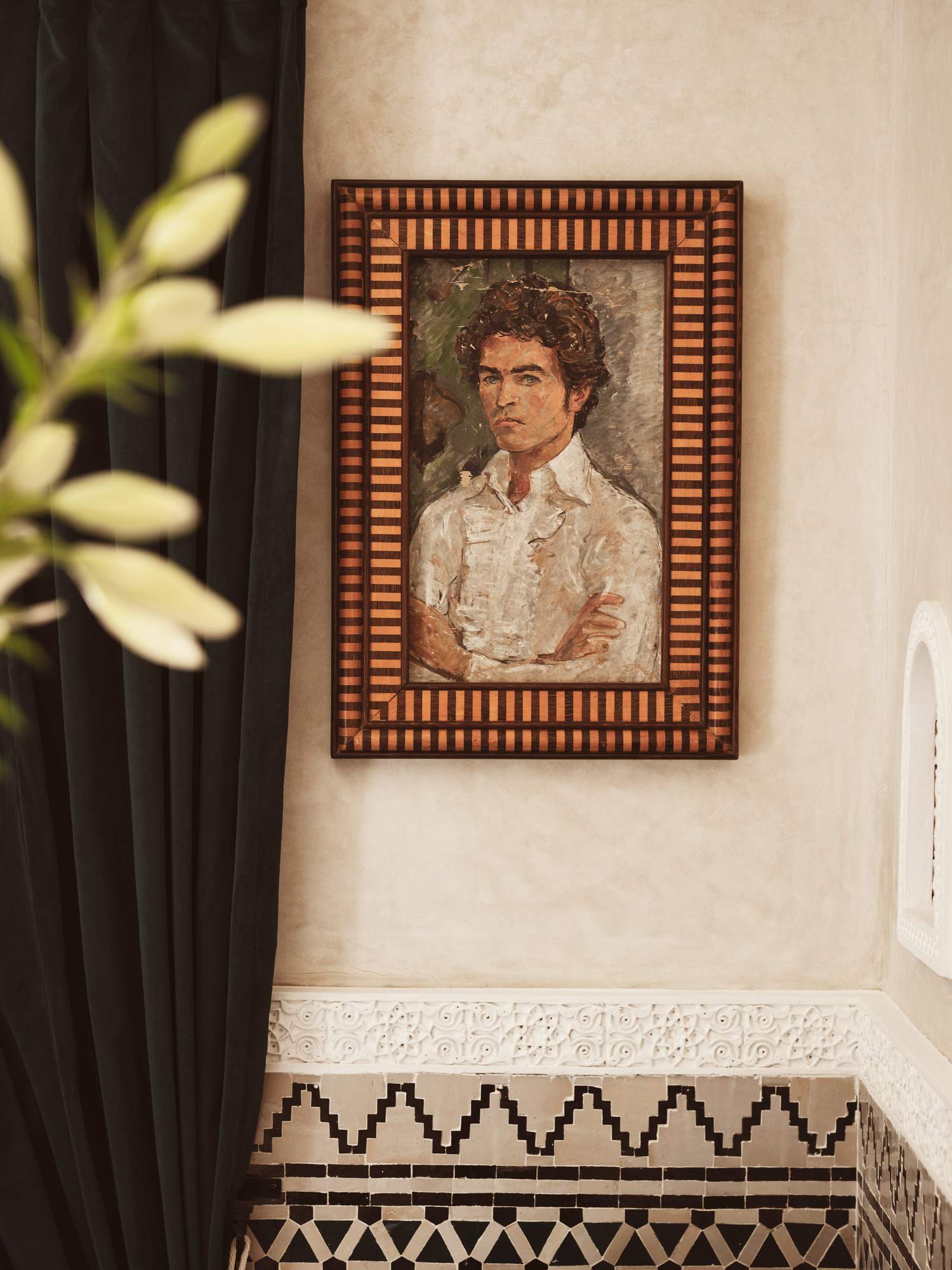 A framed portrait of a man with a mustache.