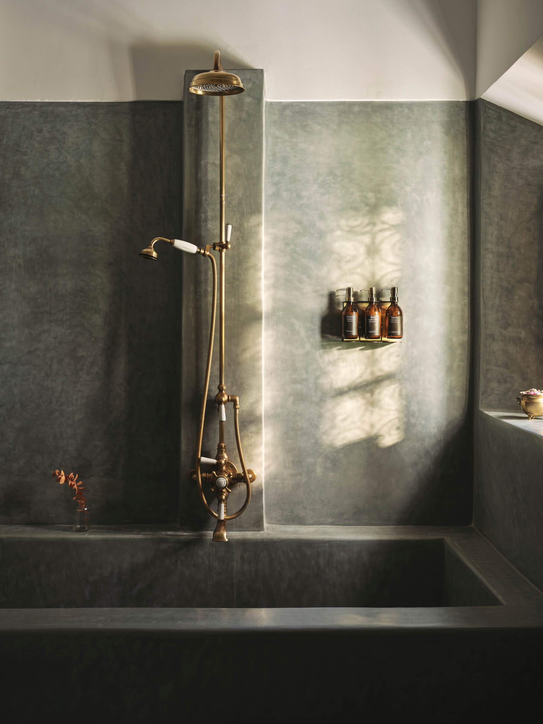 A bathroom with a bathtub and a shower head.