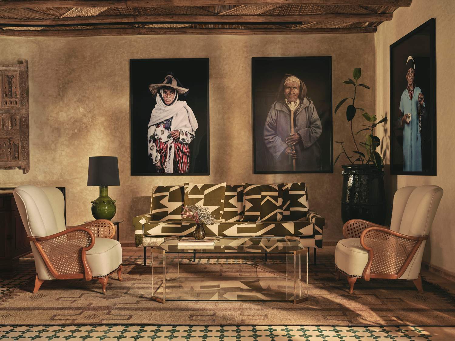 A living room with a couch and two pictures on the wall.