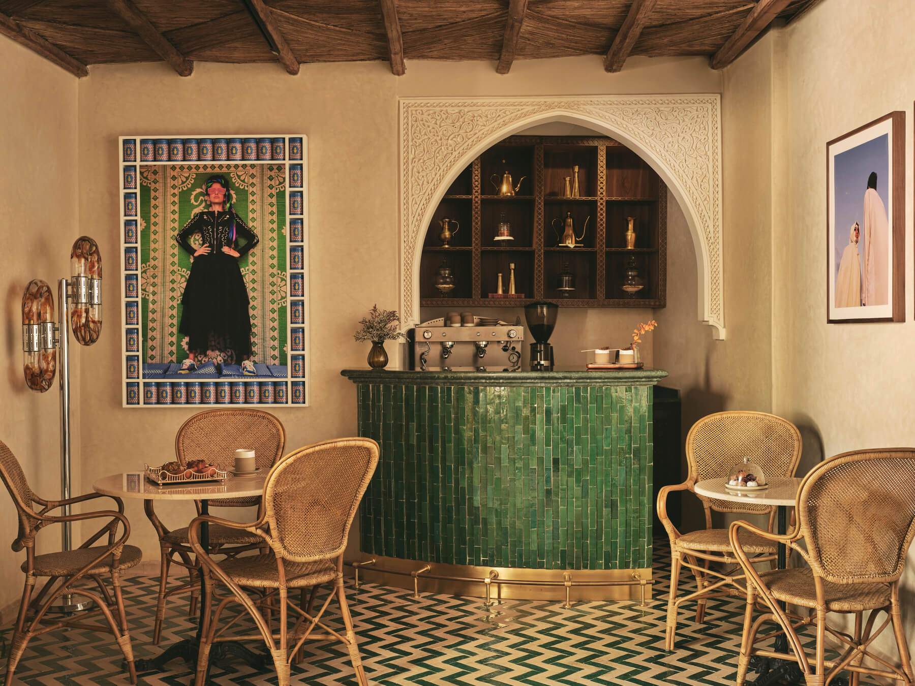 A restaurant with a bar and tables with chairs and a woman on a poster.