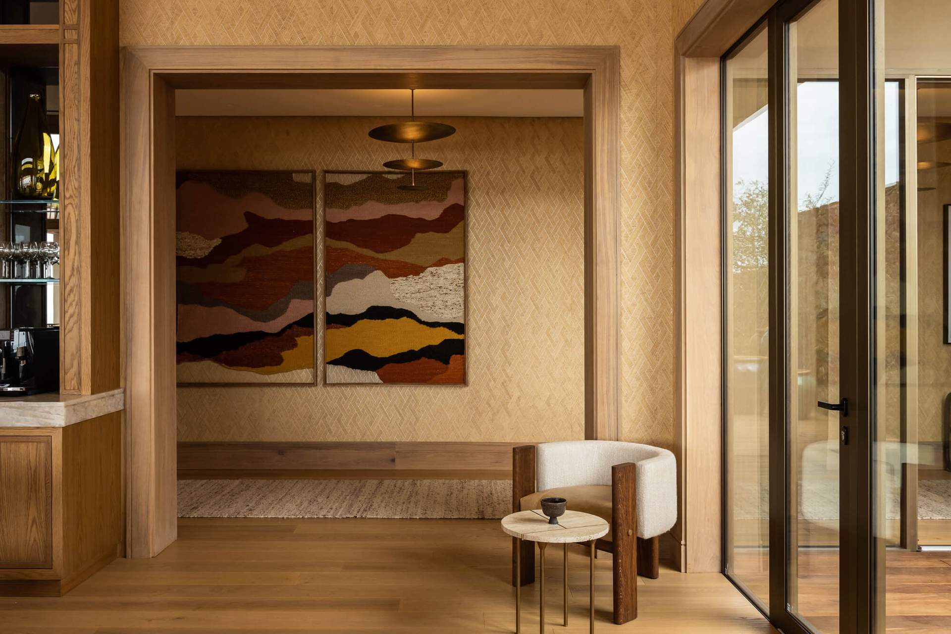 A room with a brown rug and a painting on the wall.