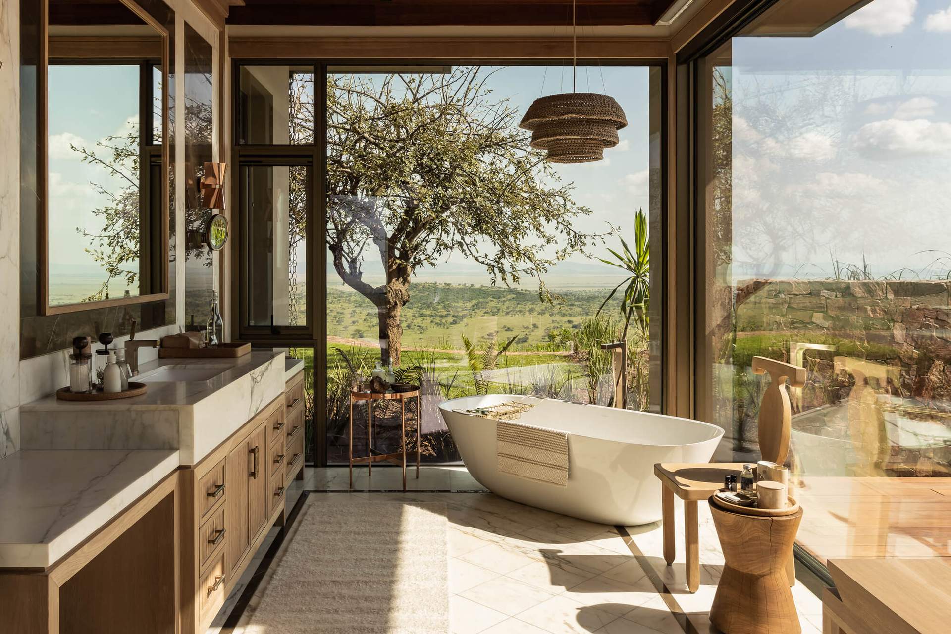 A large white bathtub with a view of the outdoors.