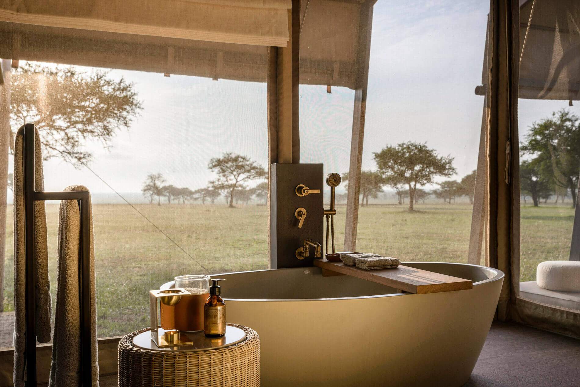 A bathroom with a bathtub and a bottle of soap.