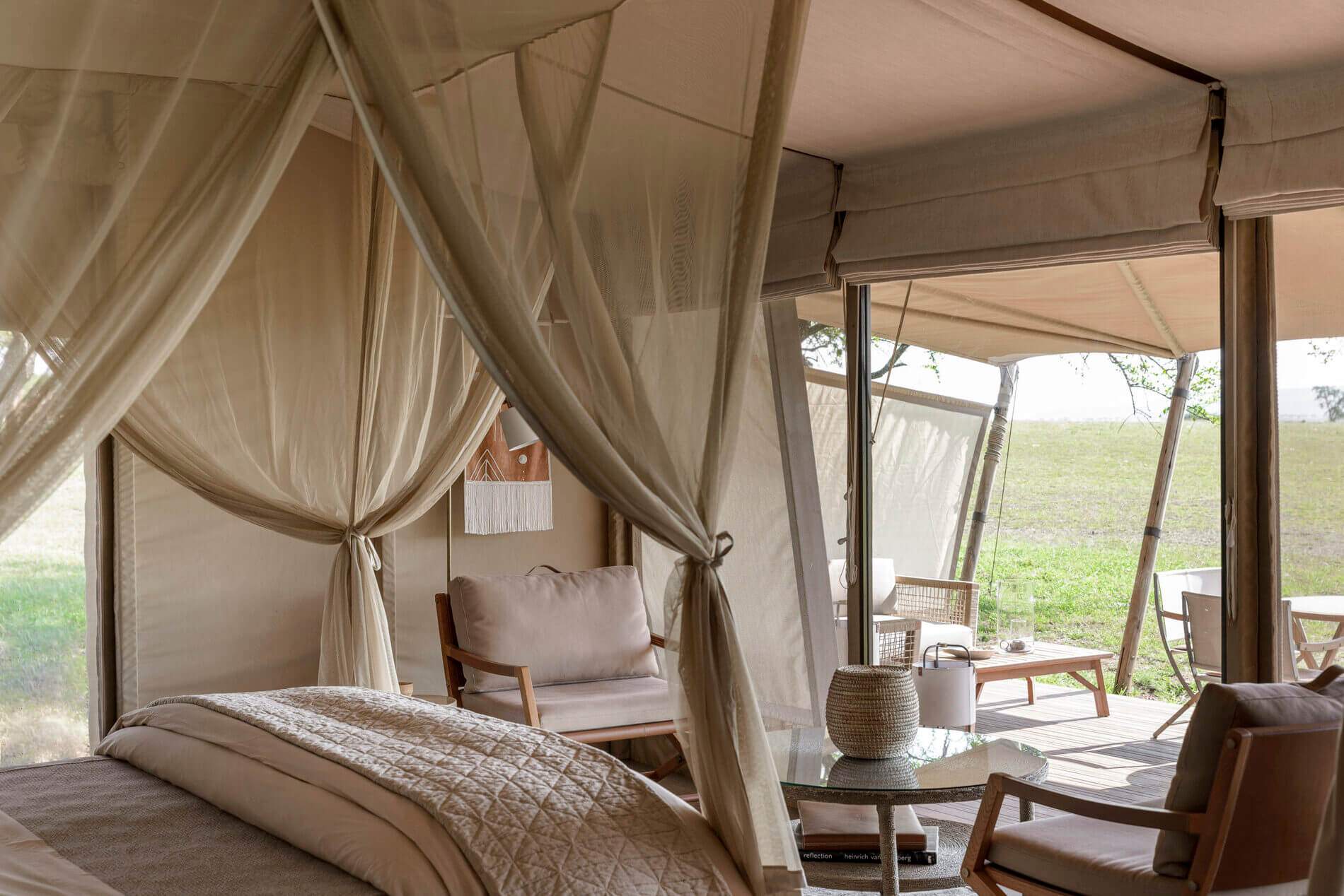 A bedroom with a bed, chair, and table.