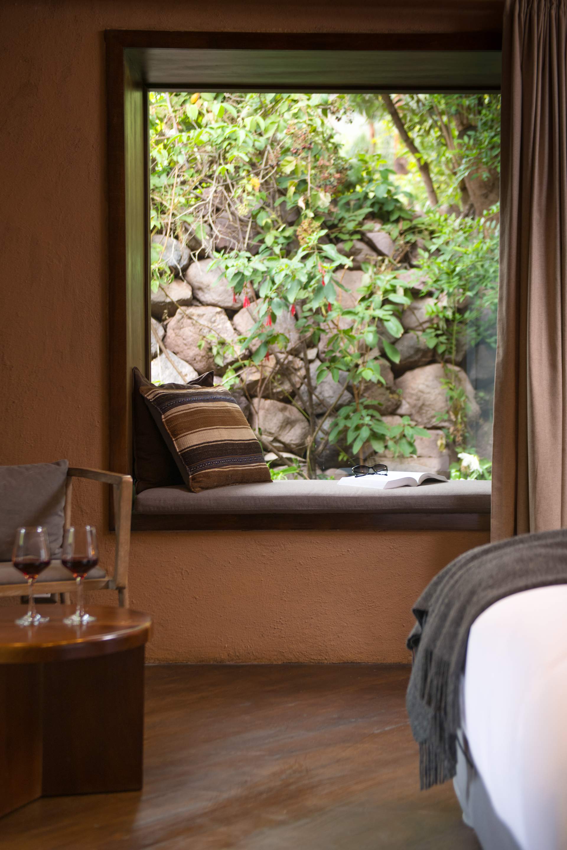 A view of a room with a bench and a window.