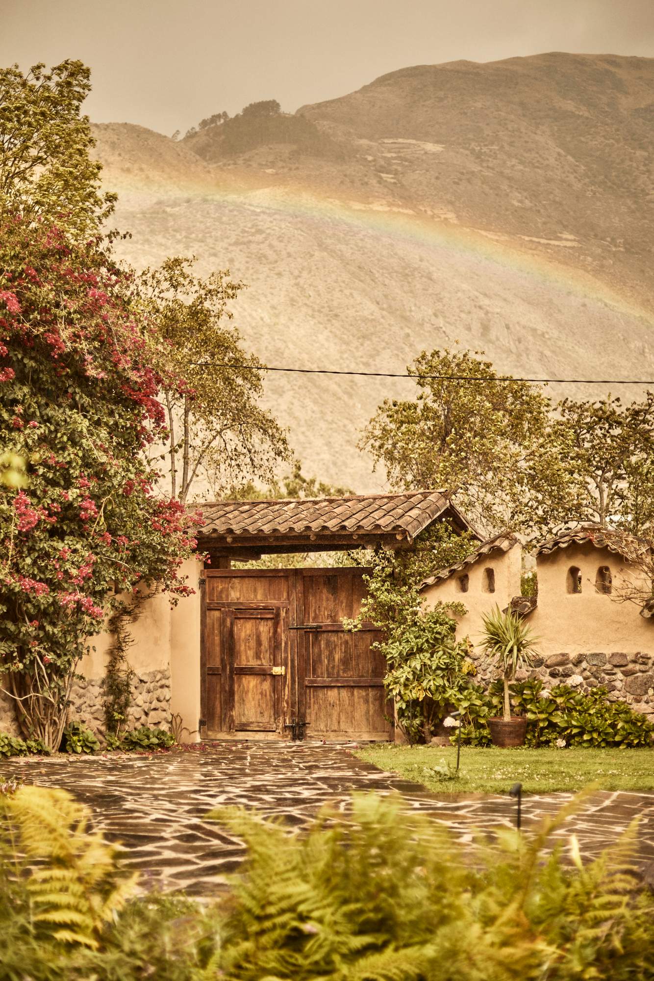 A house with a rainbow over it.