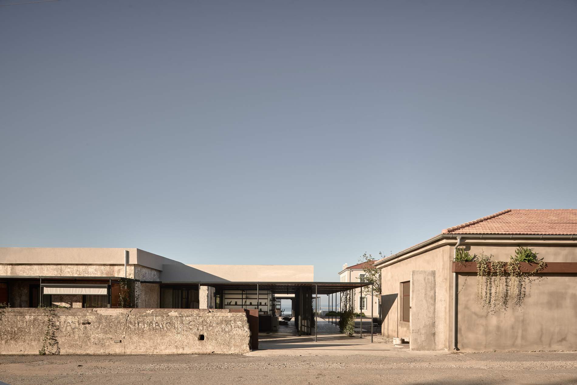 A large building with a white roof and a brick wall.