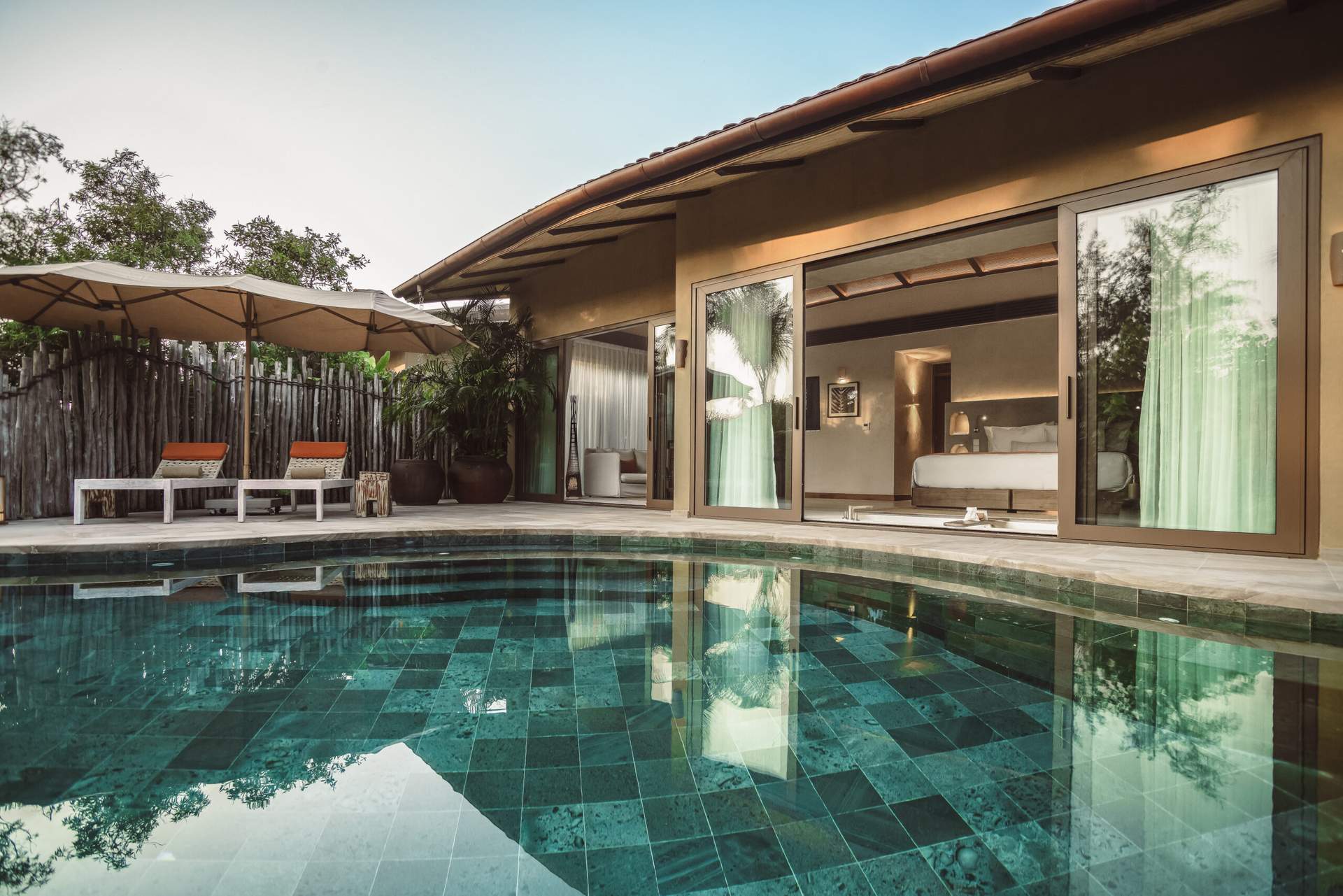A swimming pool with a house in the background.