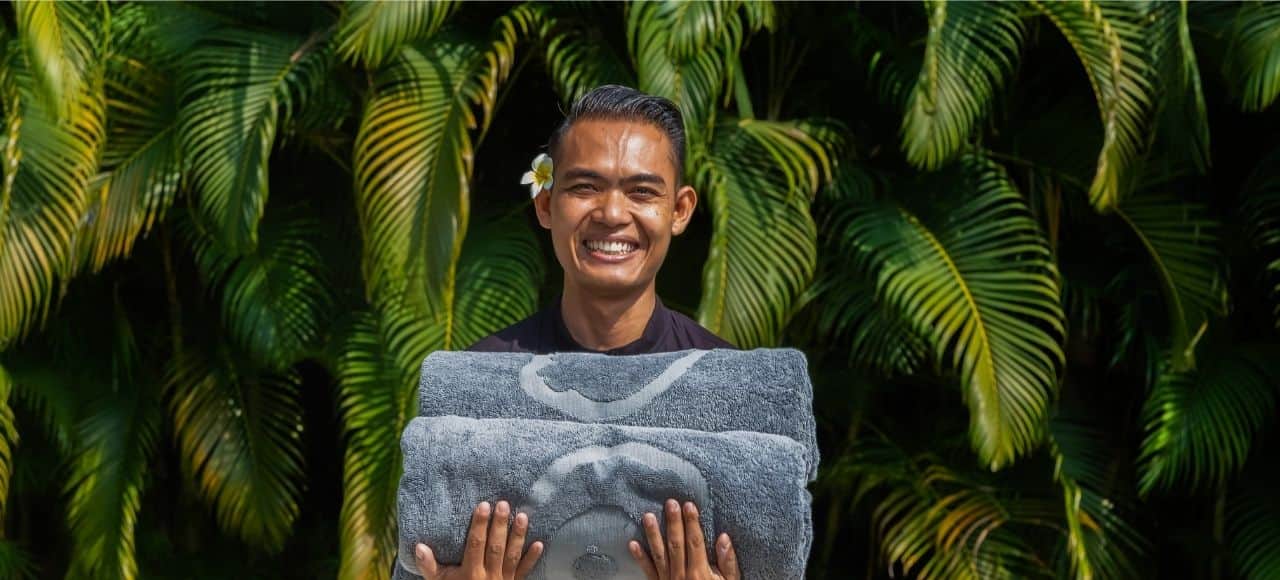 A man holding a towel with a picture of a man's face on it.