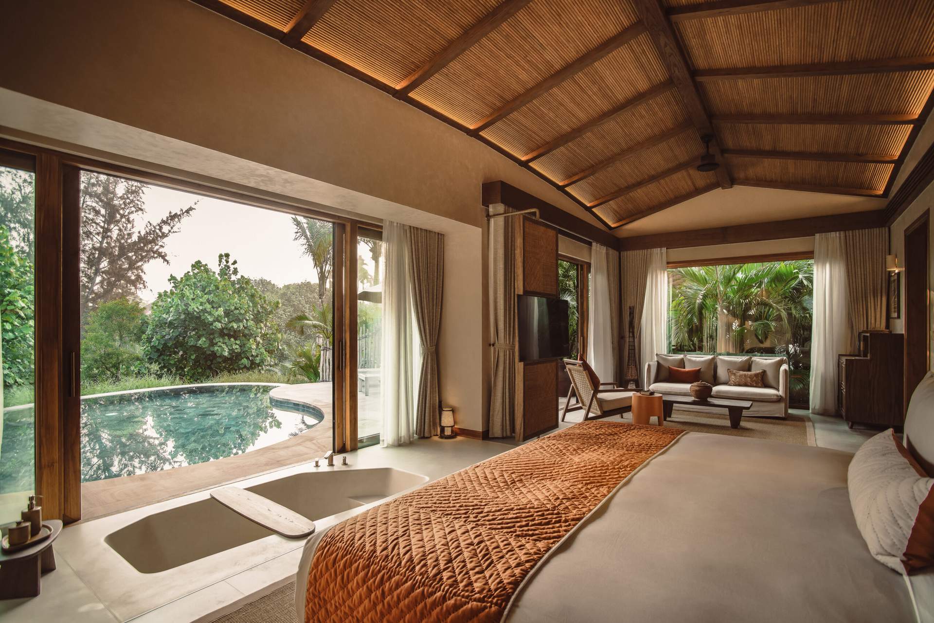 A bedroom with a bed and a window overlooking a pool.