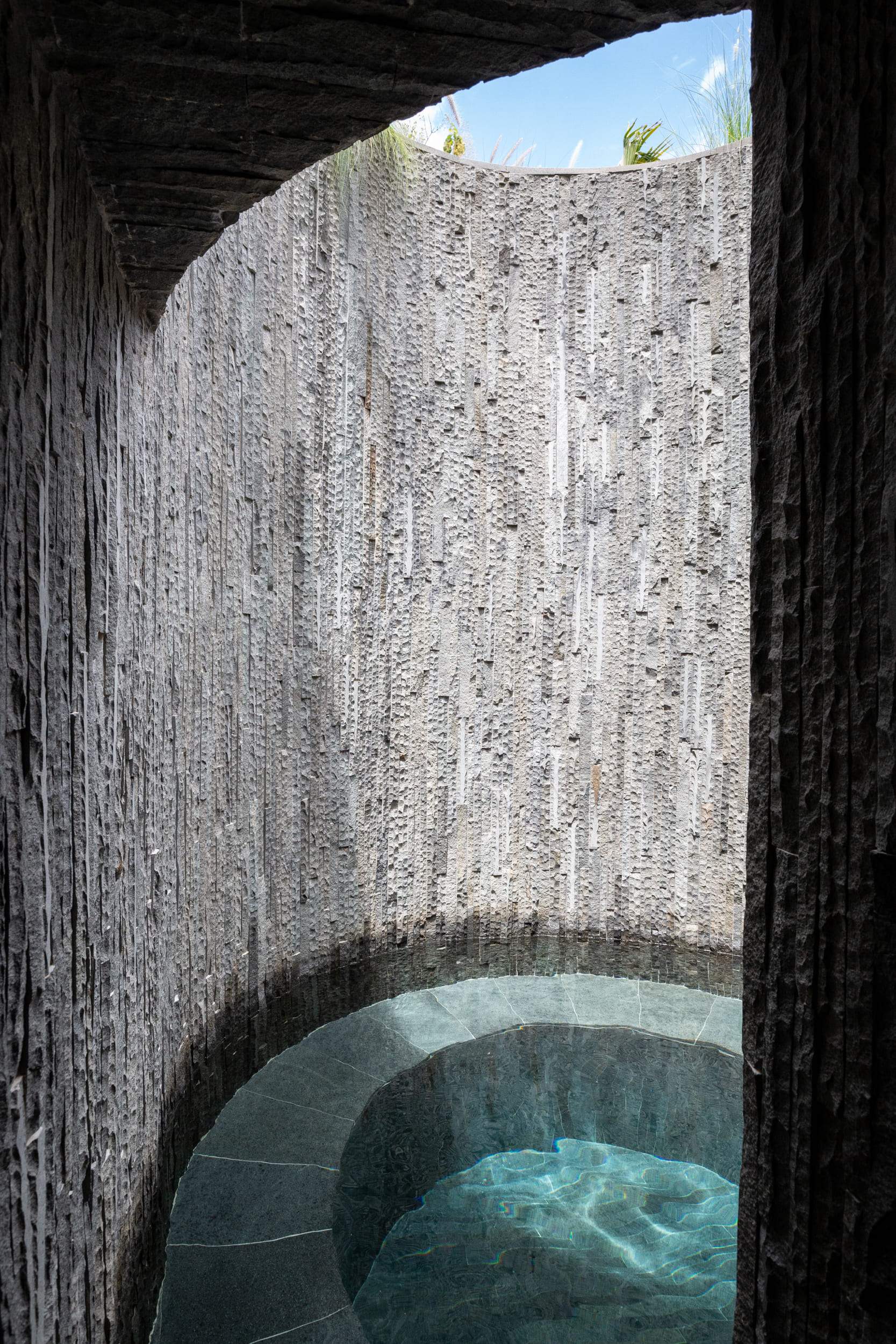 A stone wall with a hole in it.