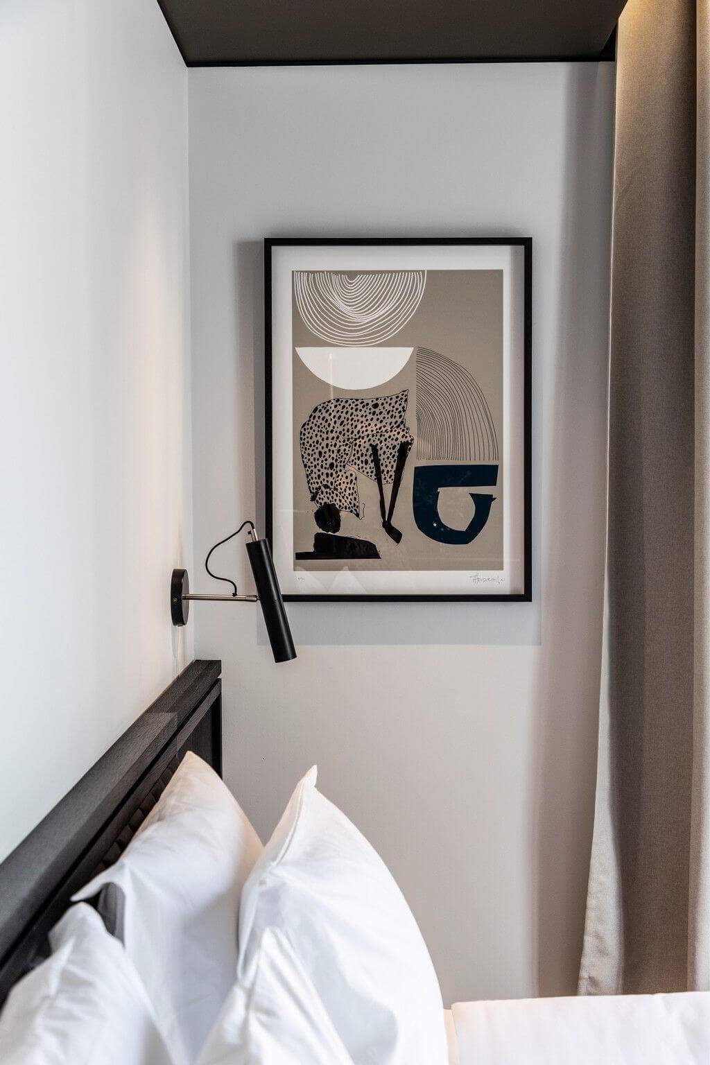 A framed picture of a leopard is hanging on a wall.
