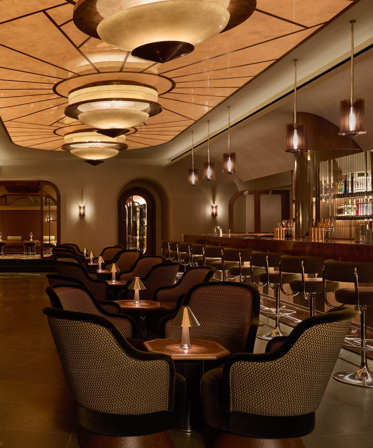 A restaurant with a bar and chairs.