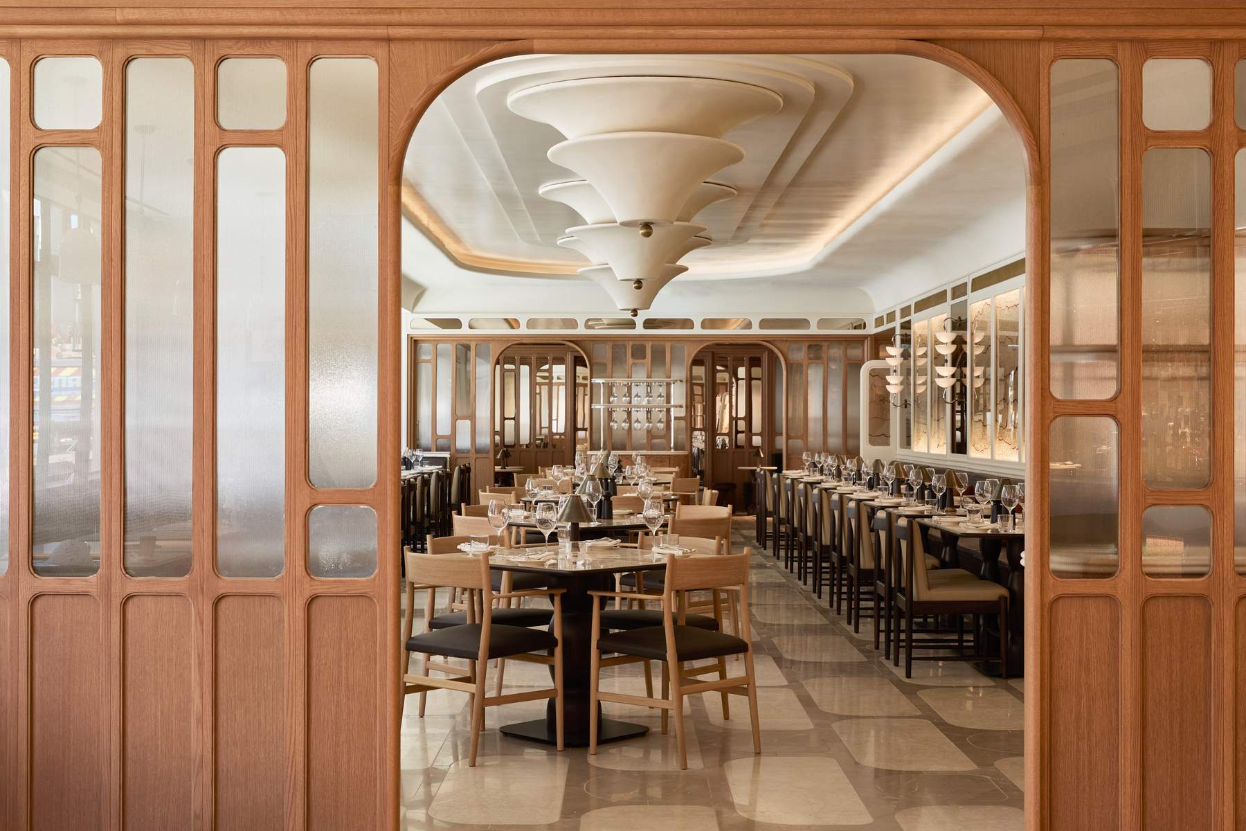 A restaurant with a large dining room and a wooden table.