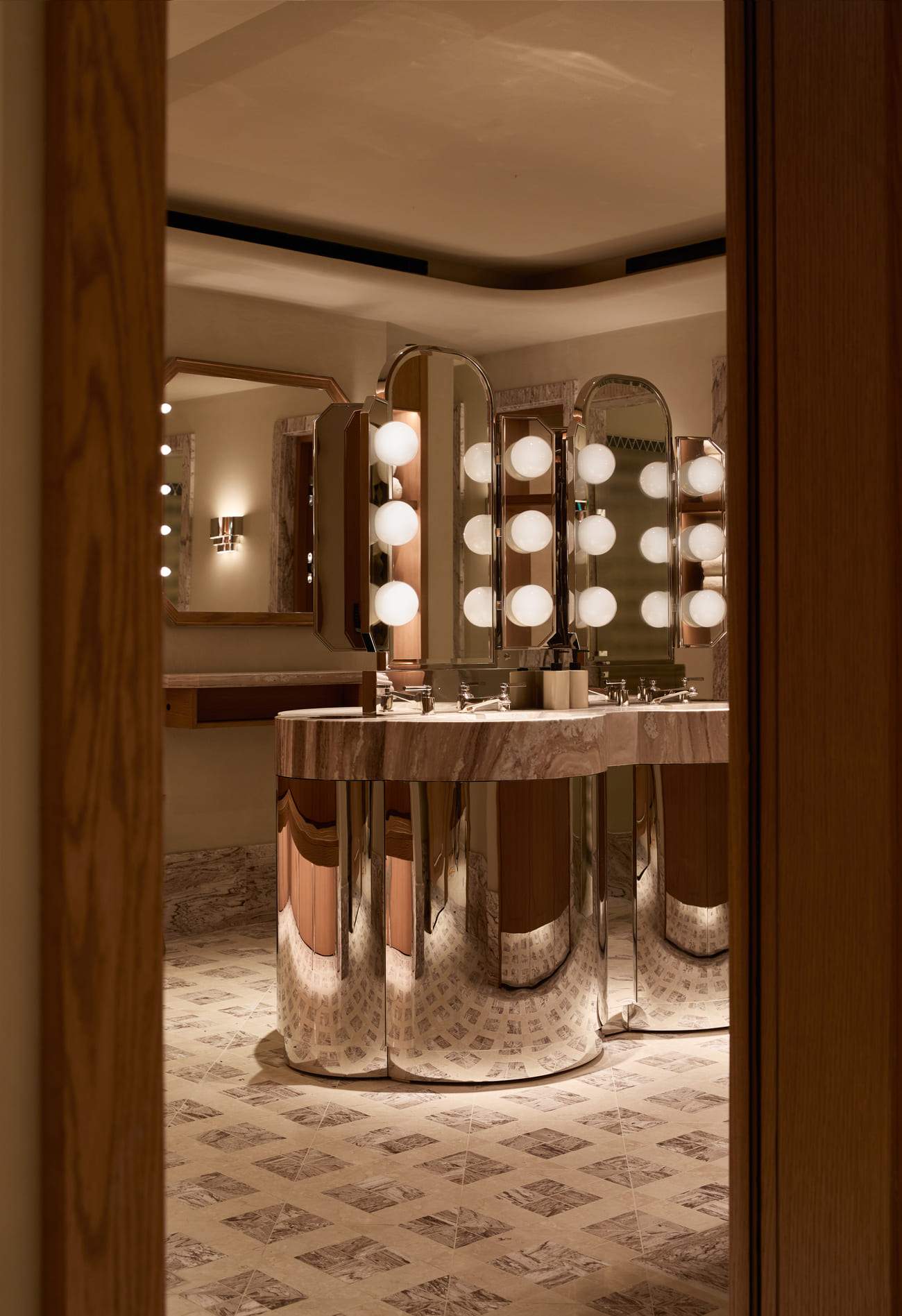 A bathroom with a large mirror and a sink.