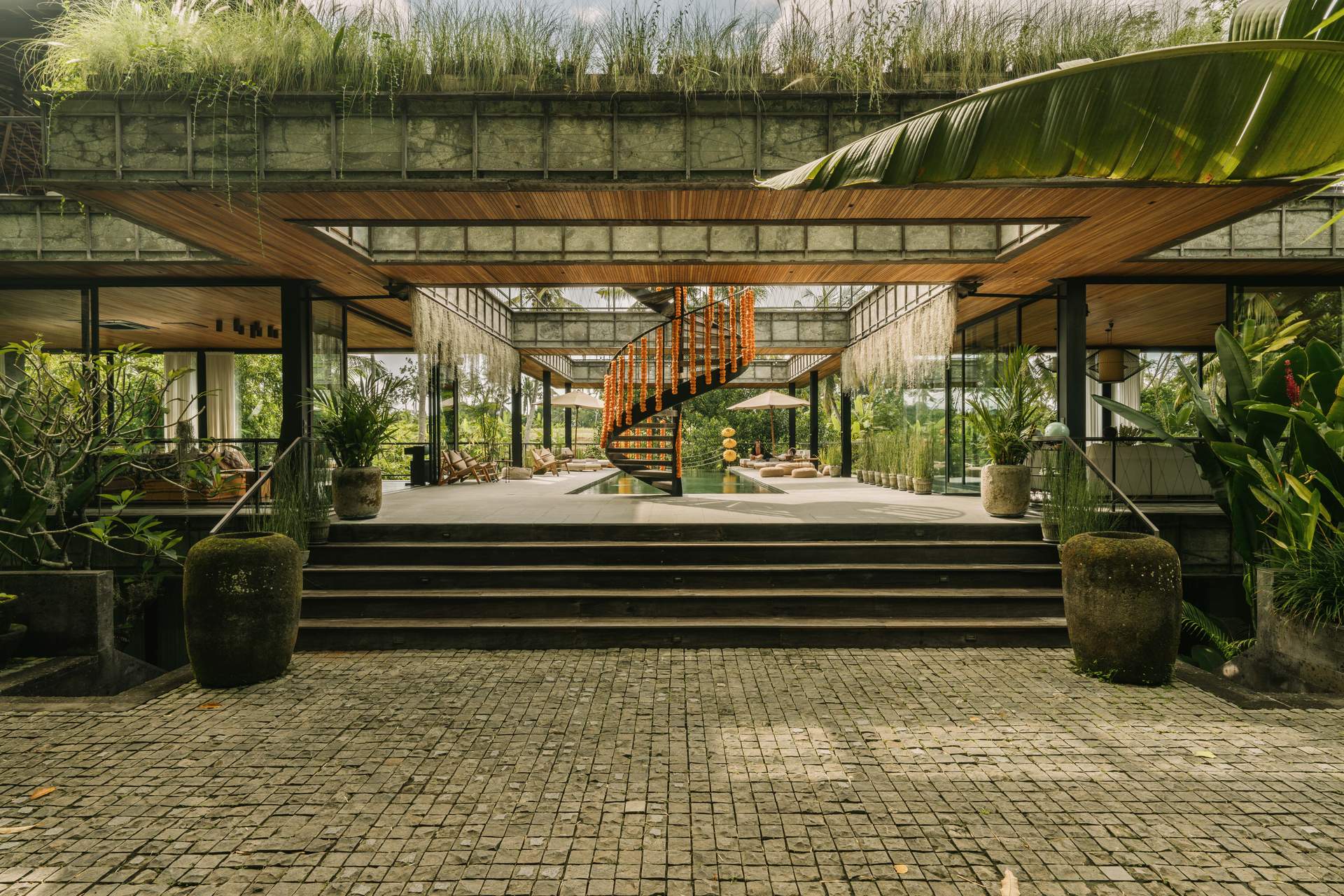 A large building with a spiral staircase and a pool.