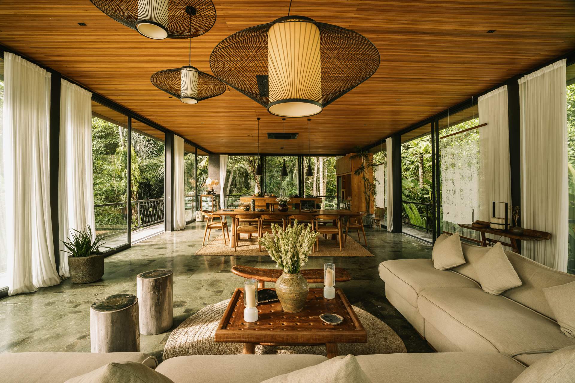 A living room with a couch, table, and chairs.