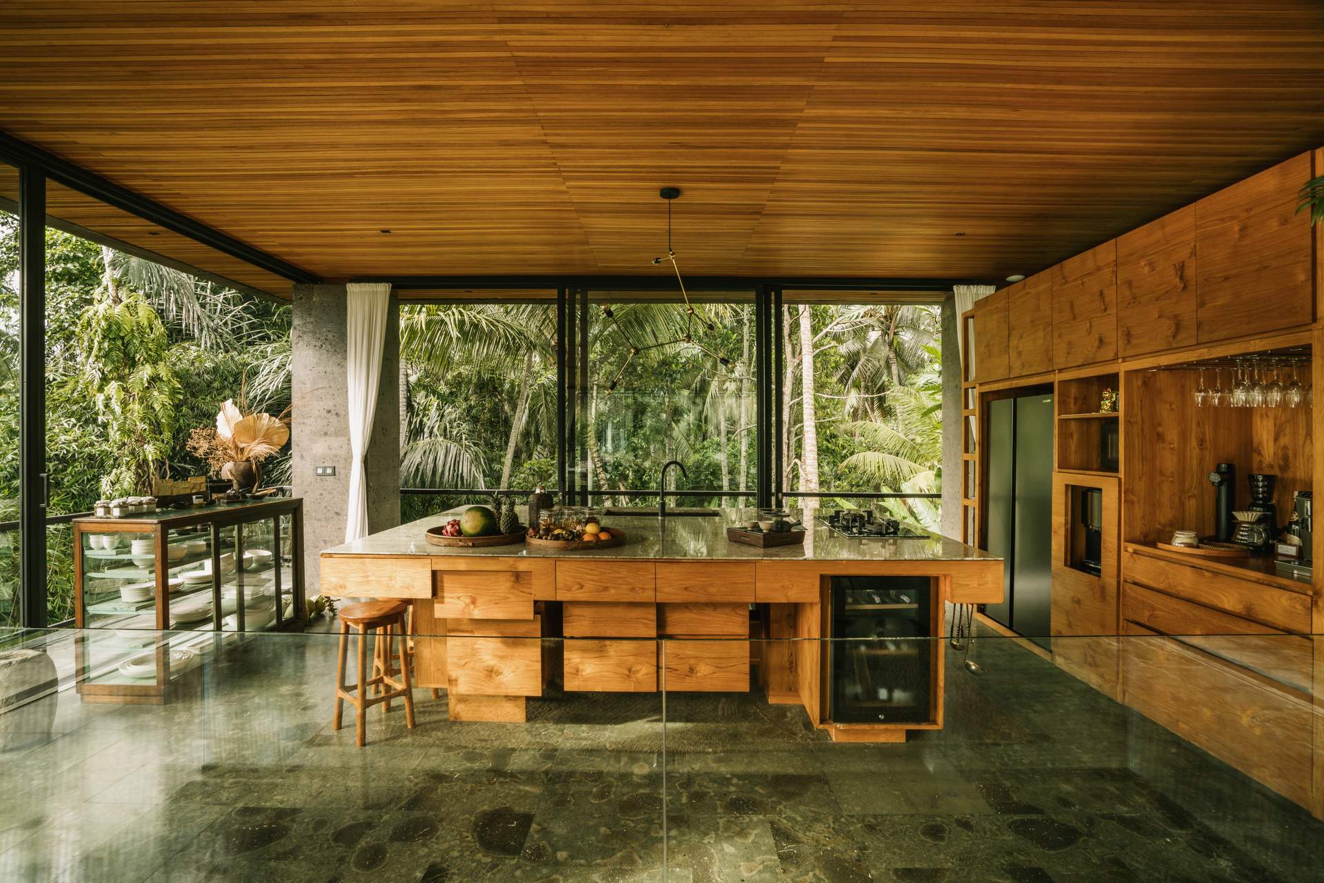A kitchen with a wooden island and a stove.