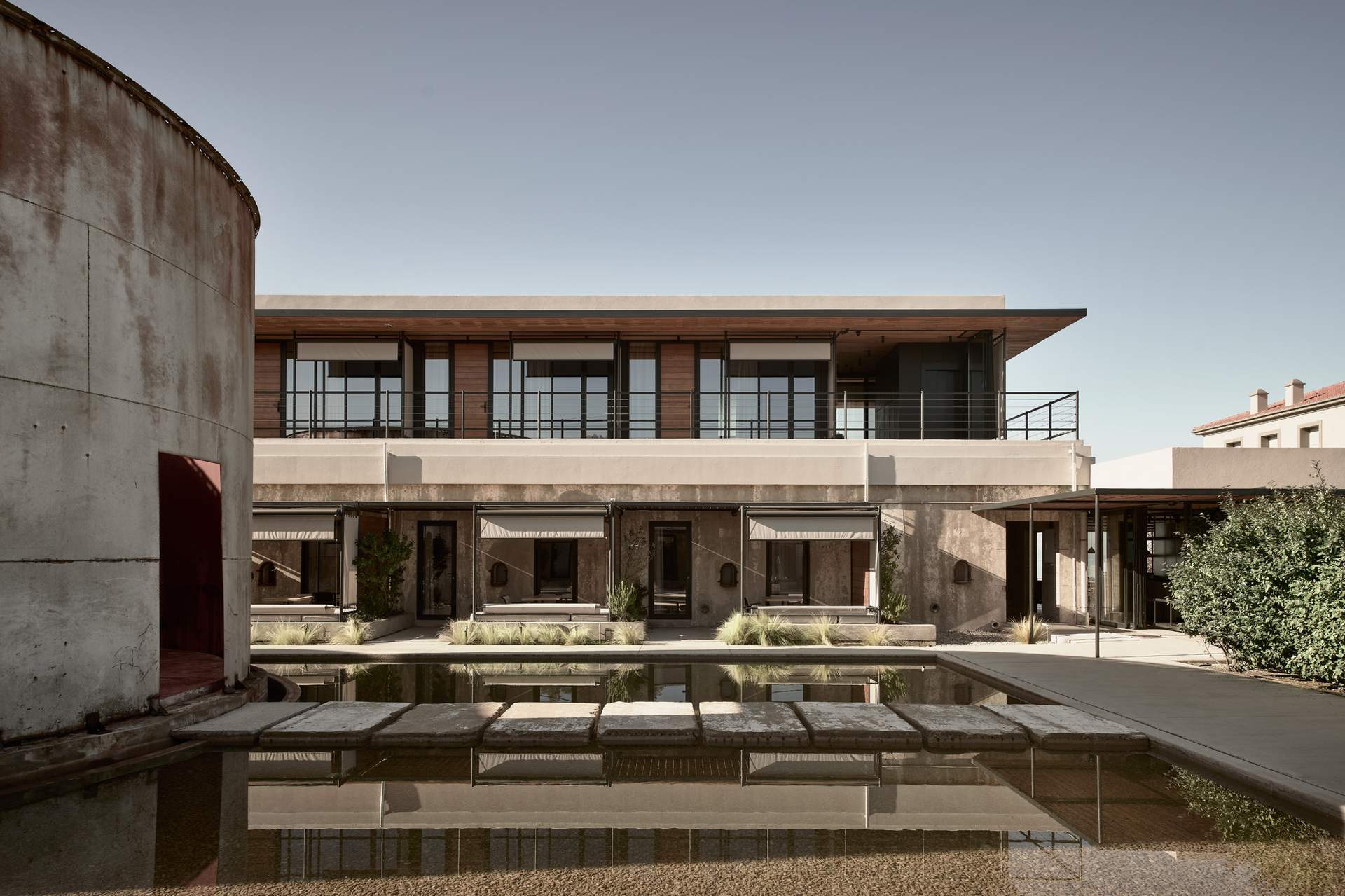 A large house with a pool and a fence.