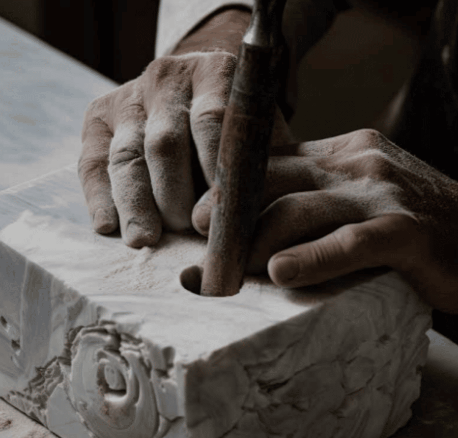 A man is carving a piece of marble.