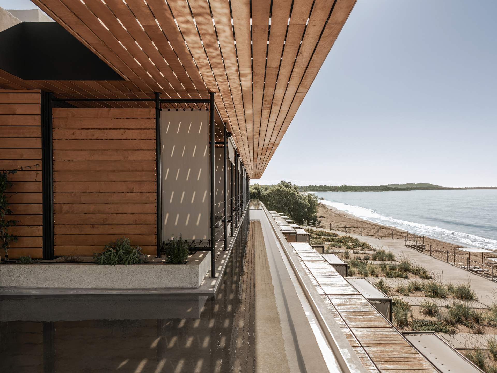 A house with a wooden deck overlooking the ocean.