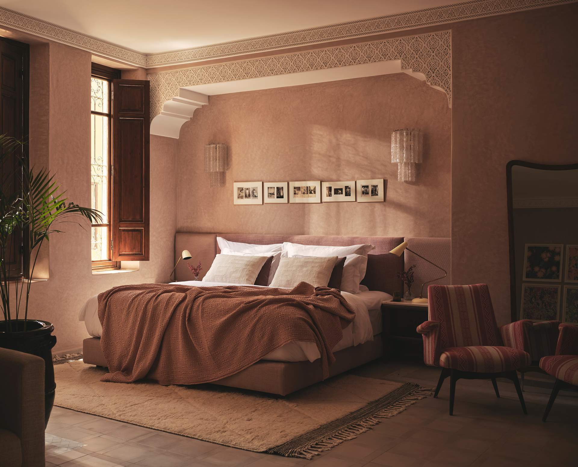 A bedroom with a bed and a chair.