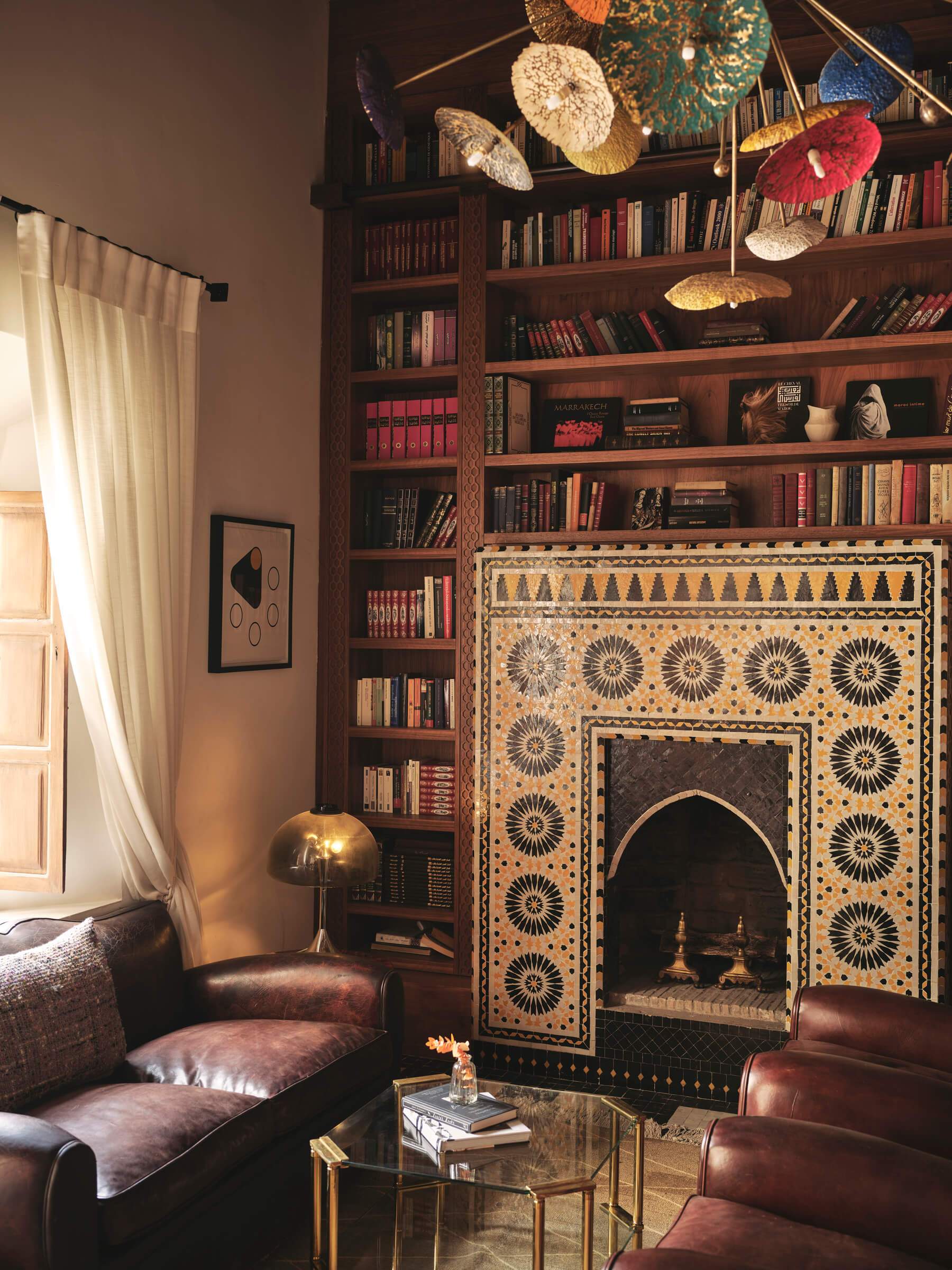 A living room with a fireplace and a bookshelf.