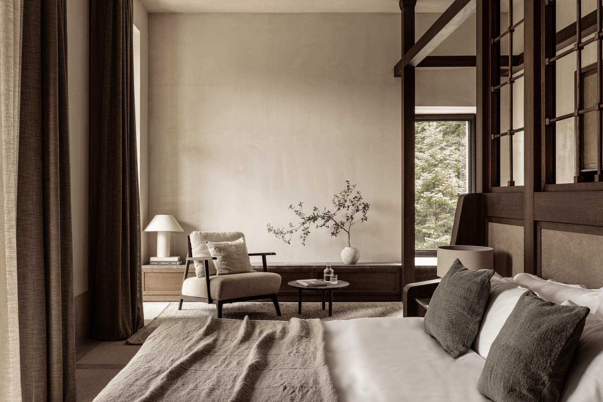A bedroom with a bed and a chair.