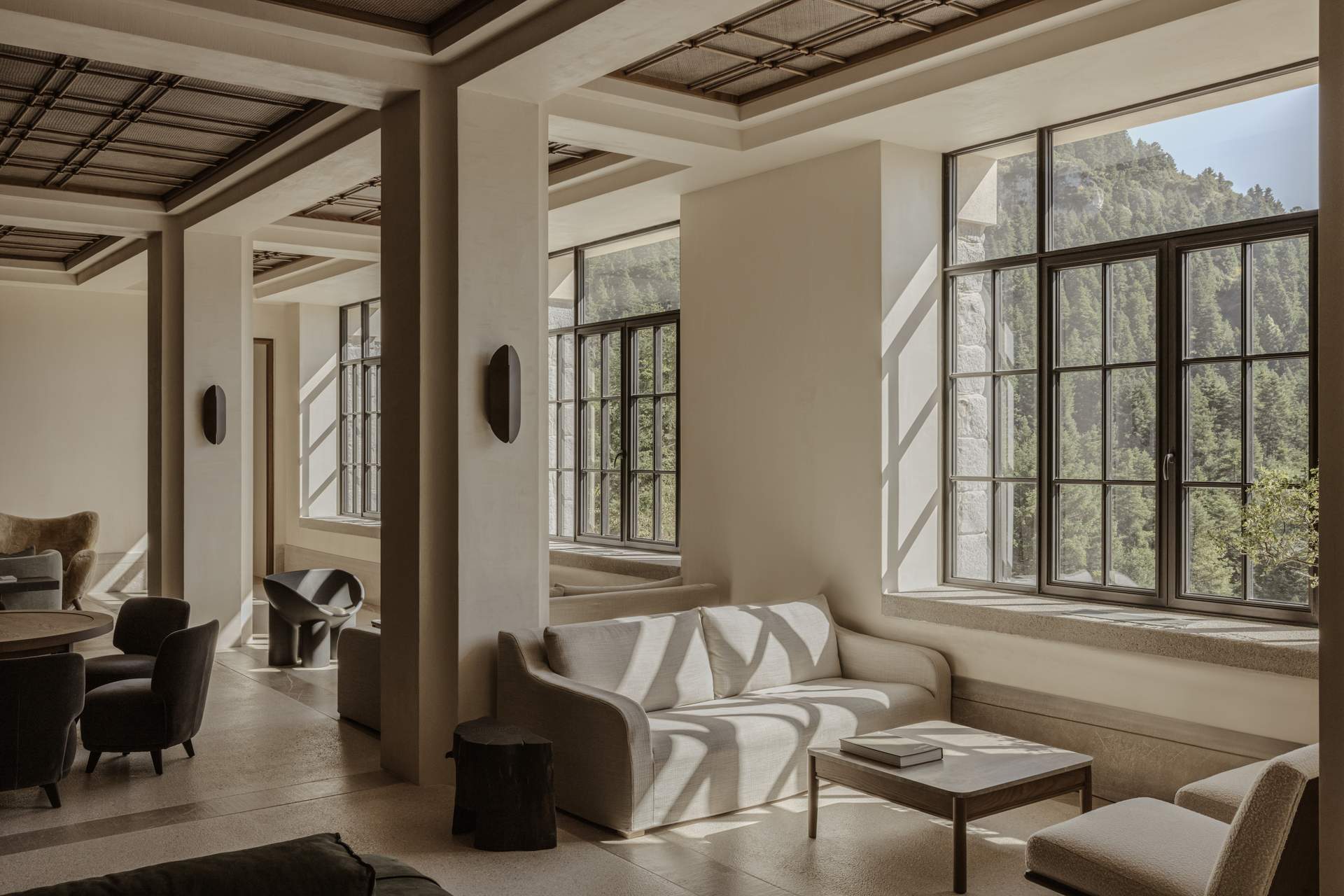 A large white room with a couch and a chair.