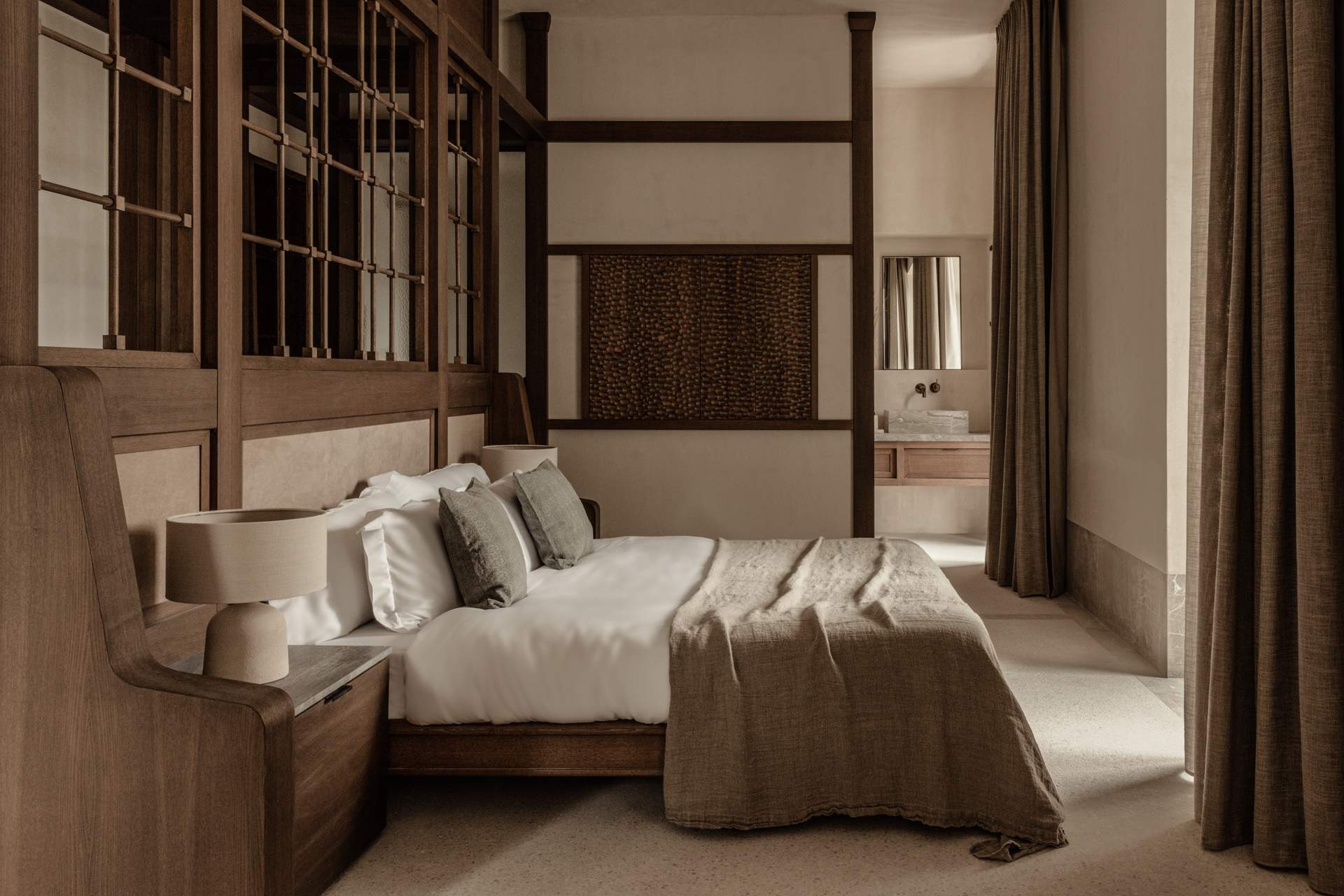 A bedroom with a bed and a lamp.