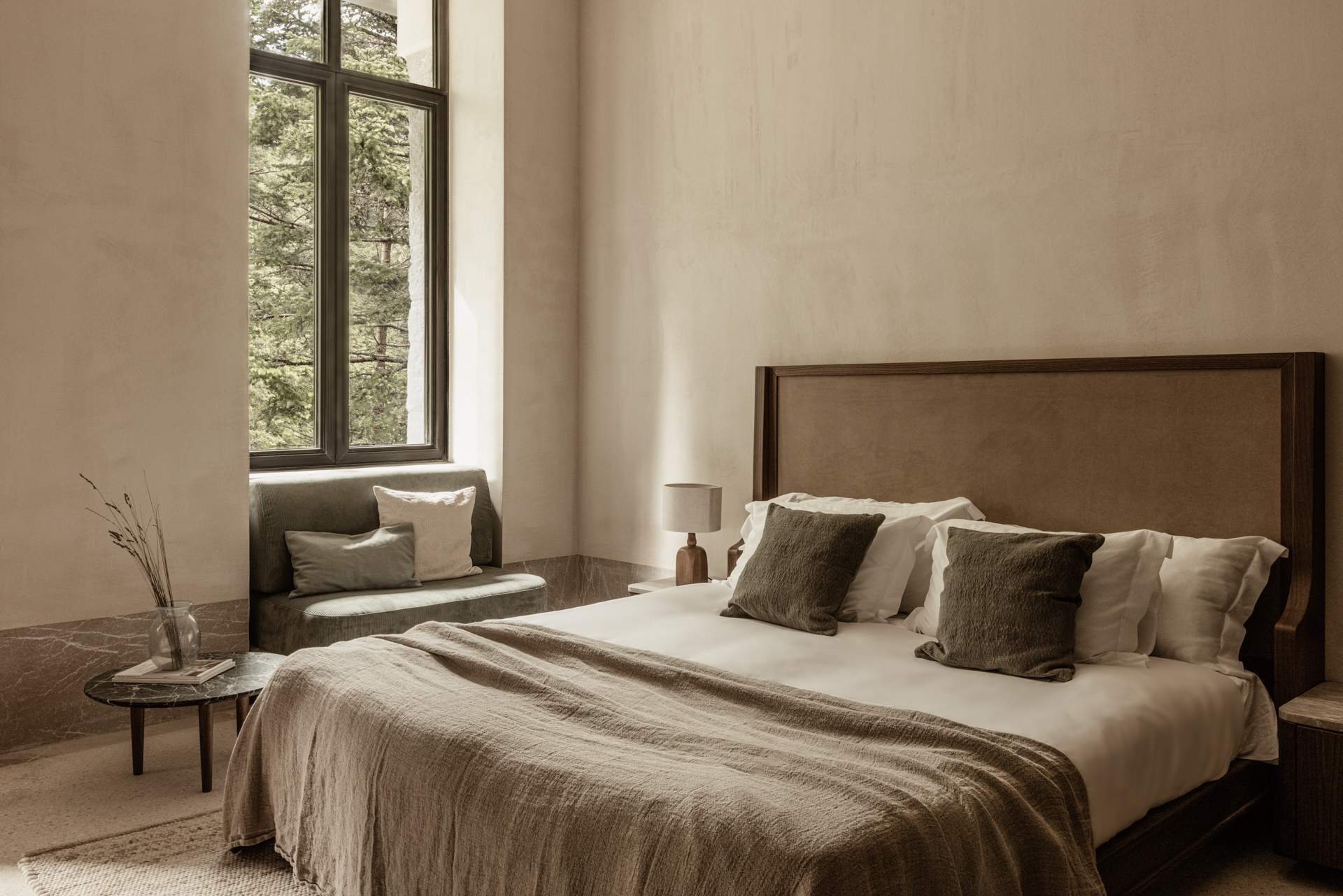 A bedroom with a bed and a lamp.