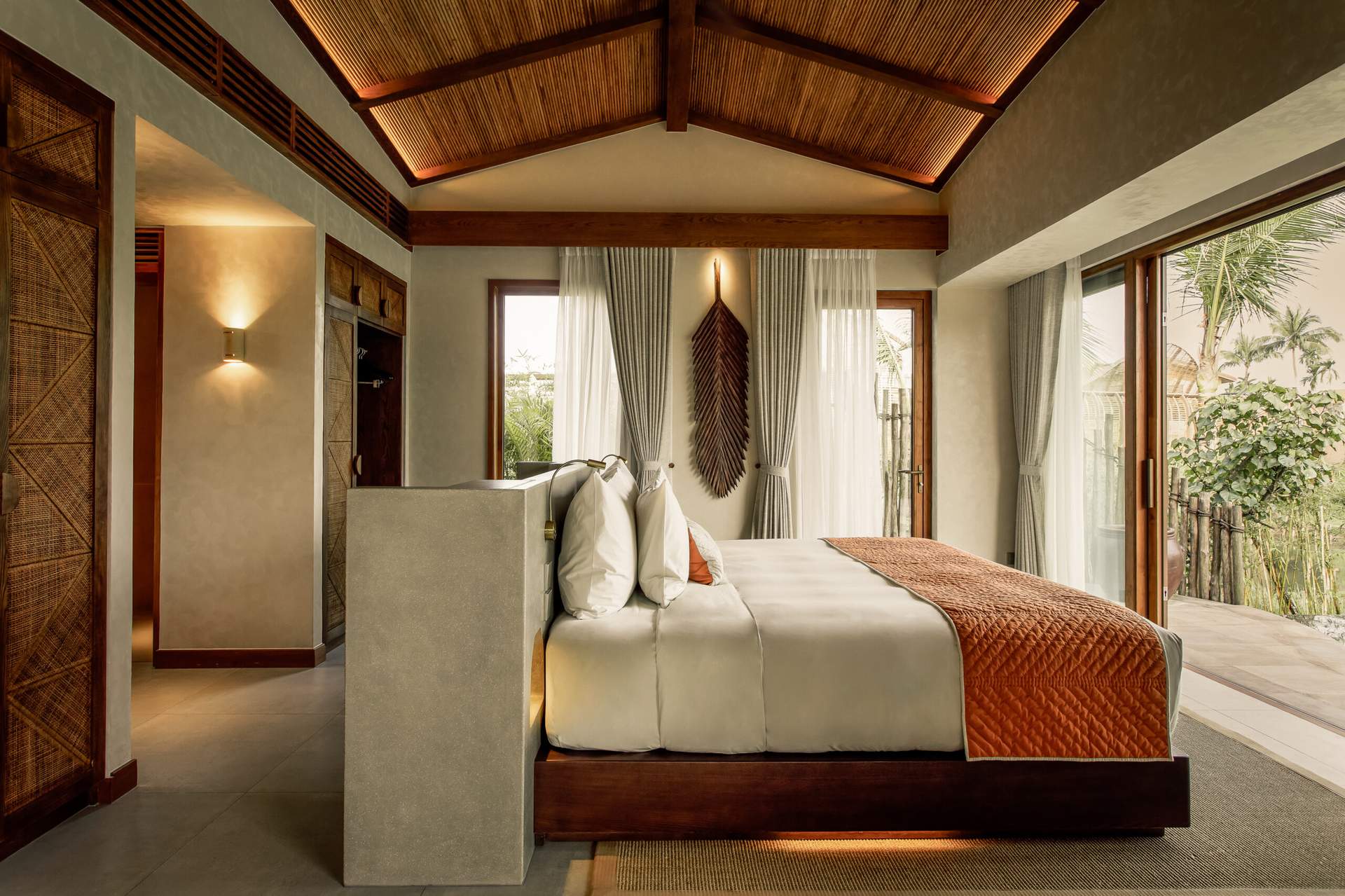 A bedroom with a bed and a television.