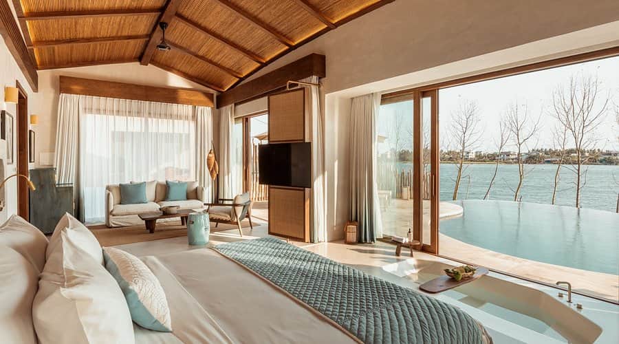 A bedroom with a bed and a television.