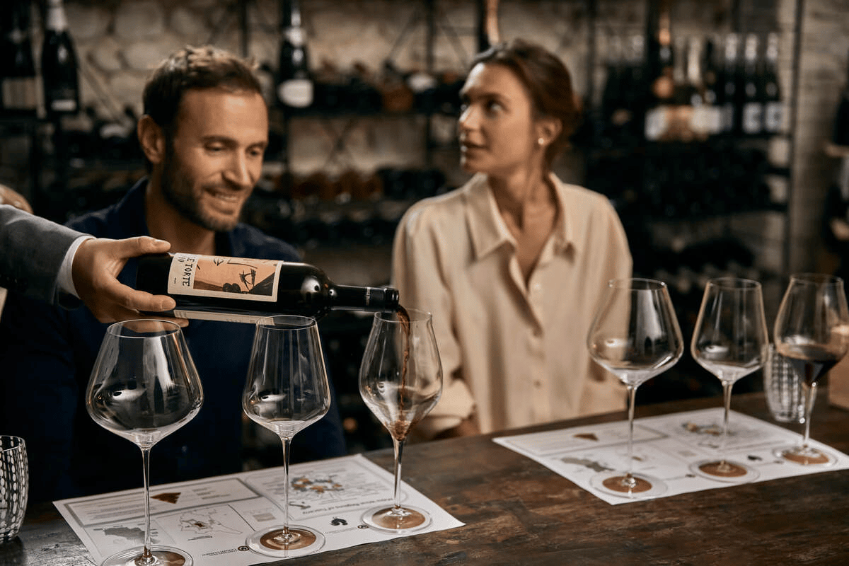 Guests at a wine tasting with glasses on a bar