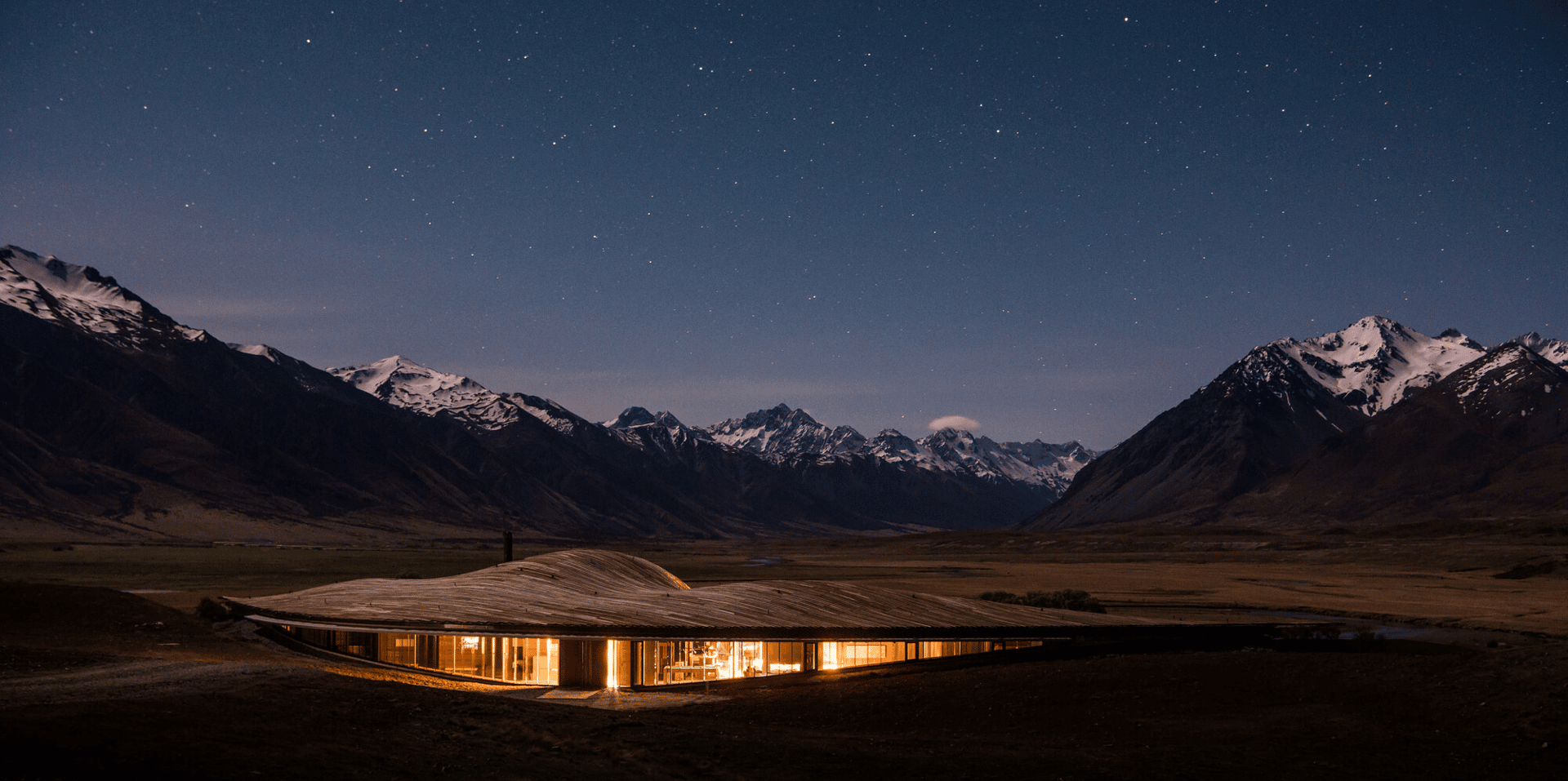 Mountain valley beneath a starry night sky