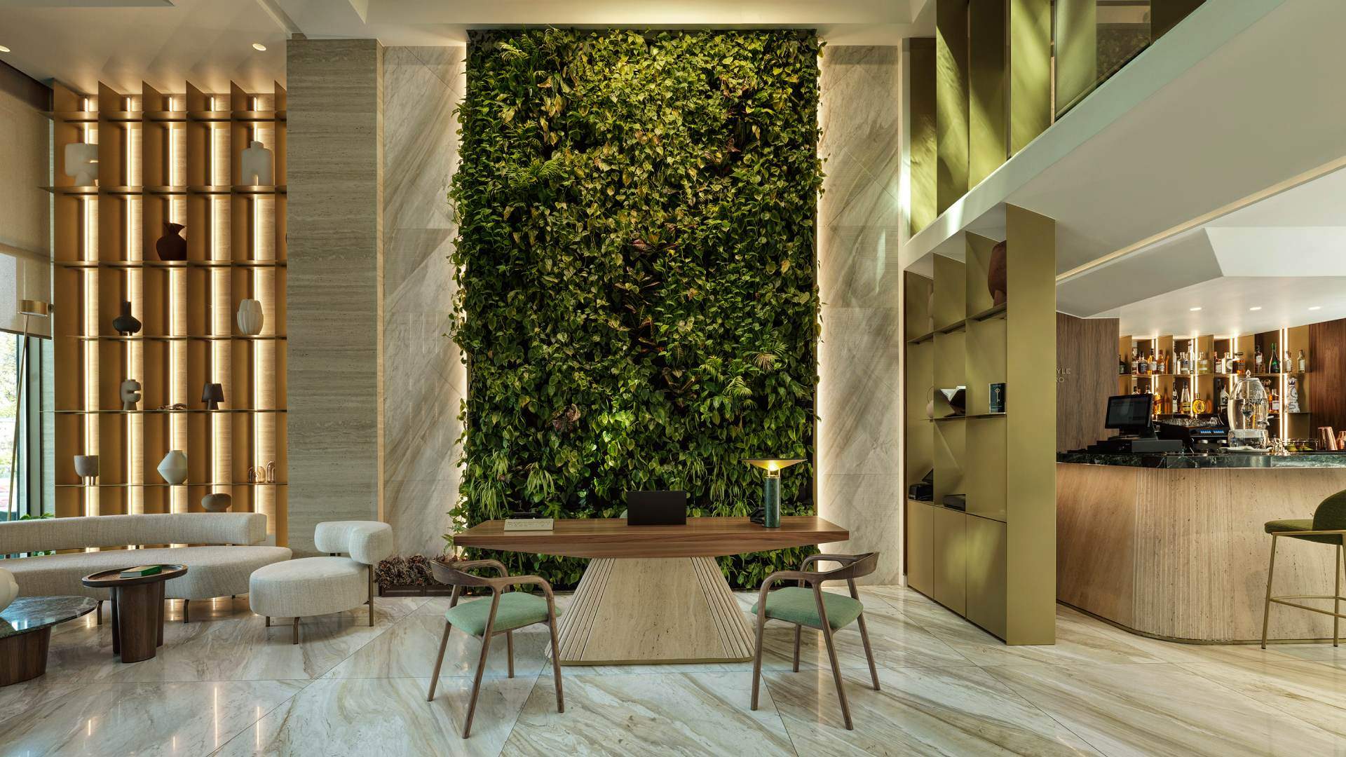 A living room with a green wall and a table with a laptop on it.