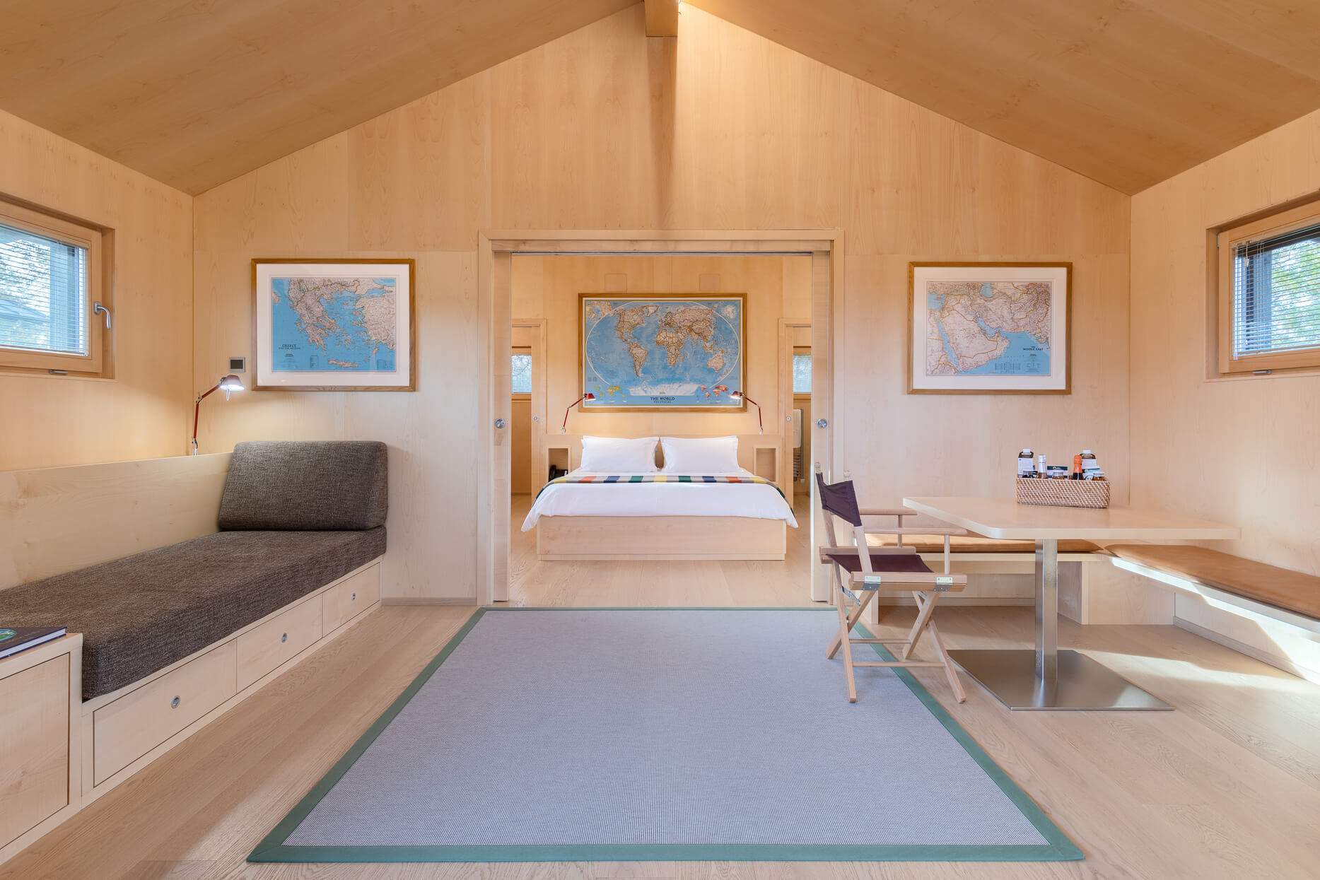 A room with a bed, a table, and a chair.