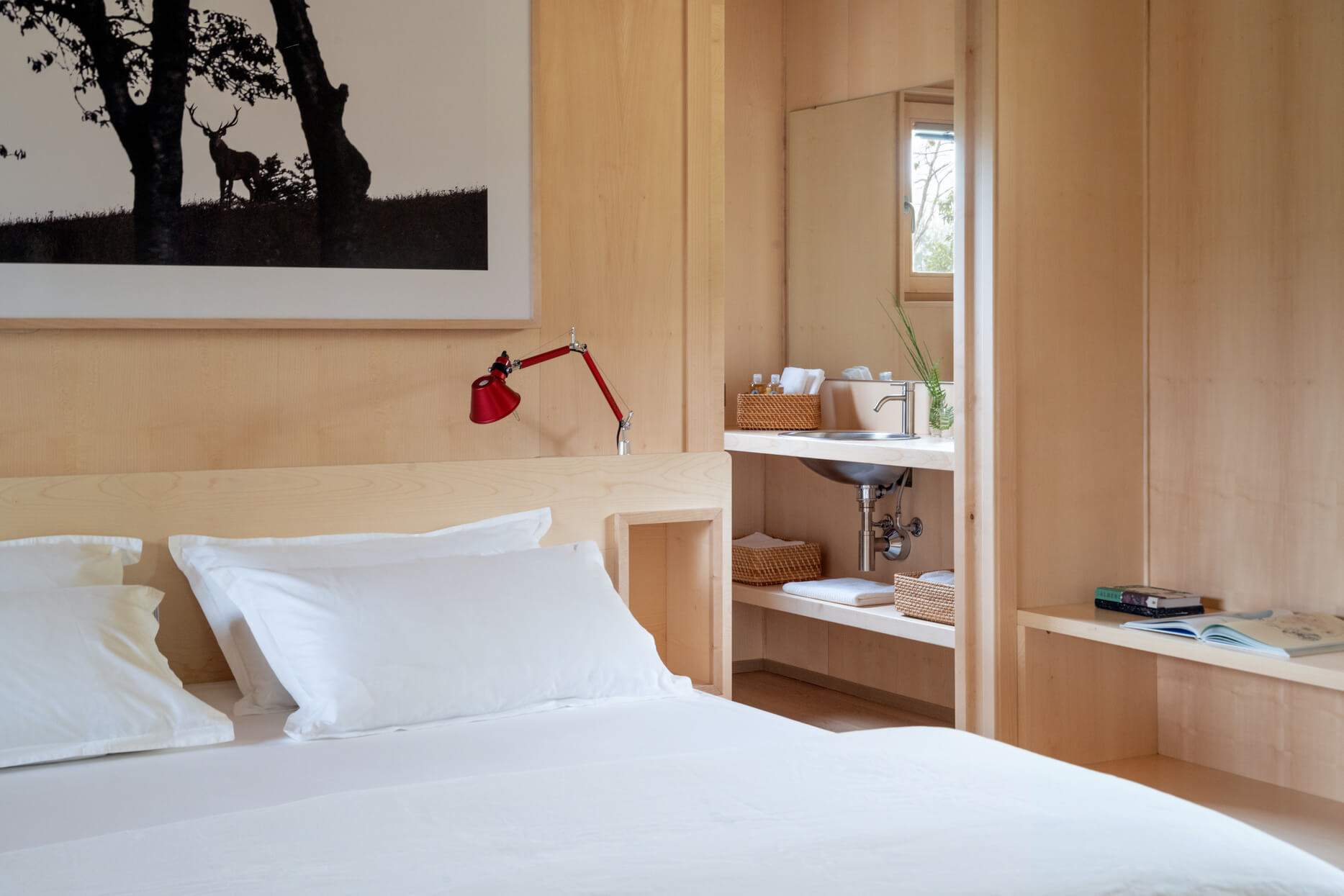 A bedroom with a bed and a mirror.