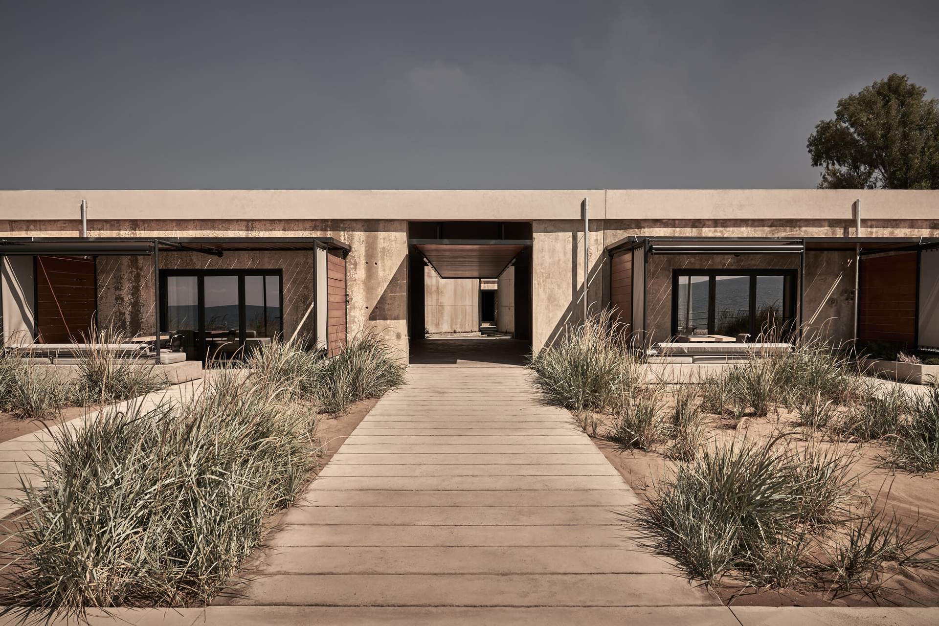 A concrete walkway leading to a building with a doorway.
