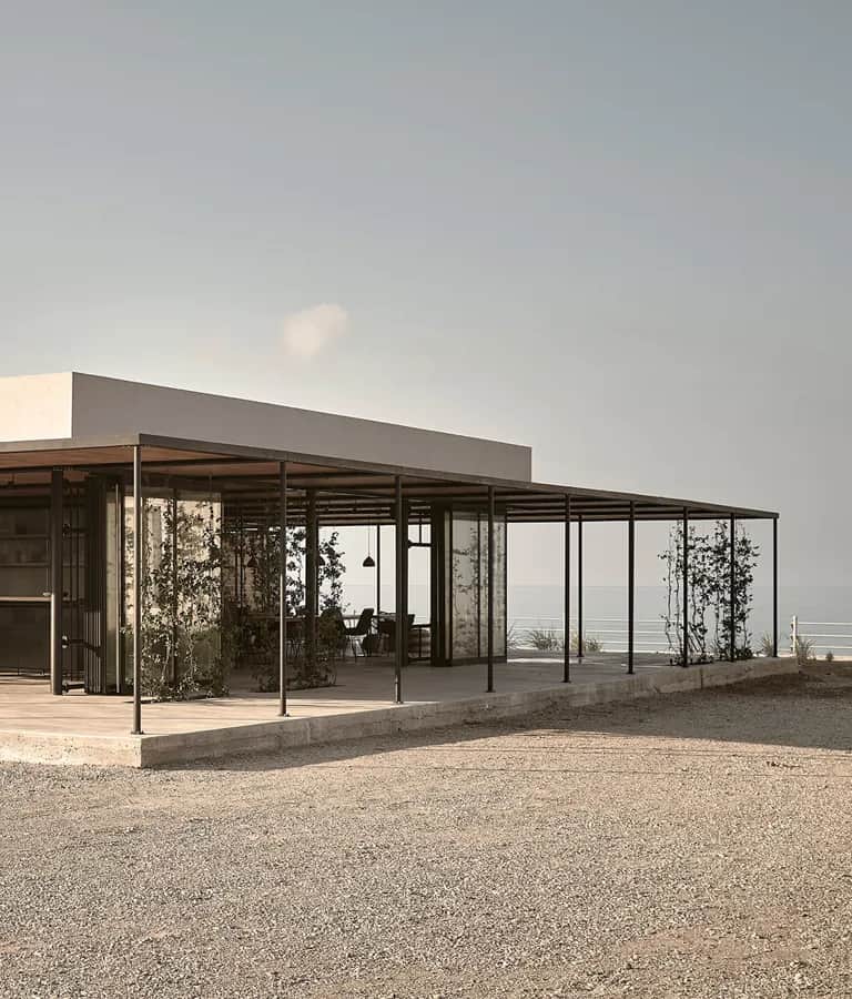 A house with a large patio and a view of the ocean.