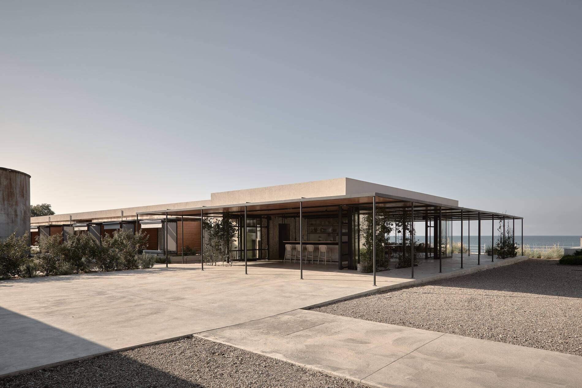A large house with a patio and a view of the ocean.