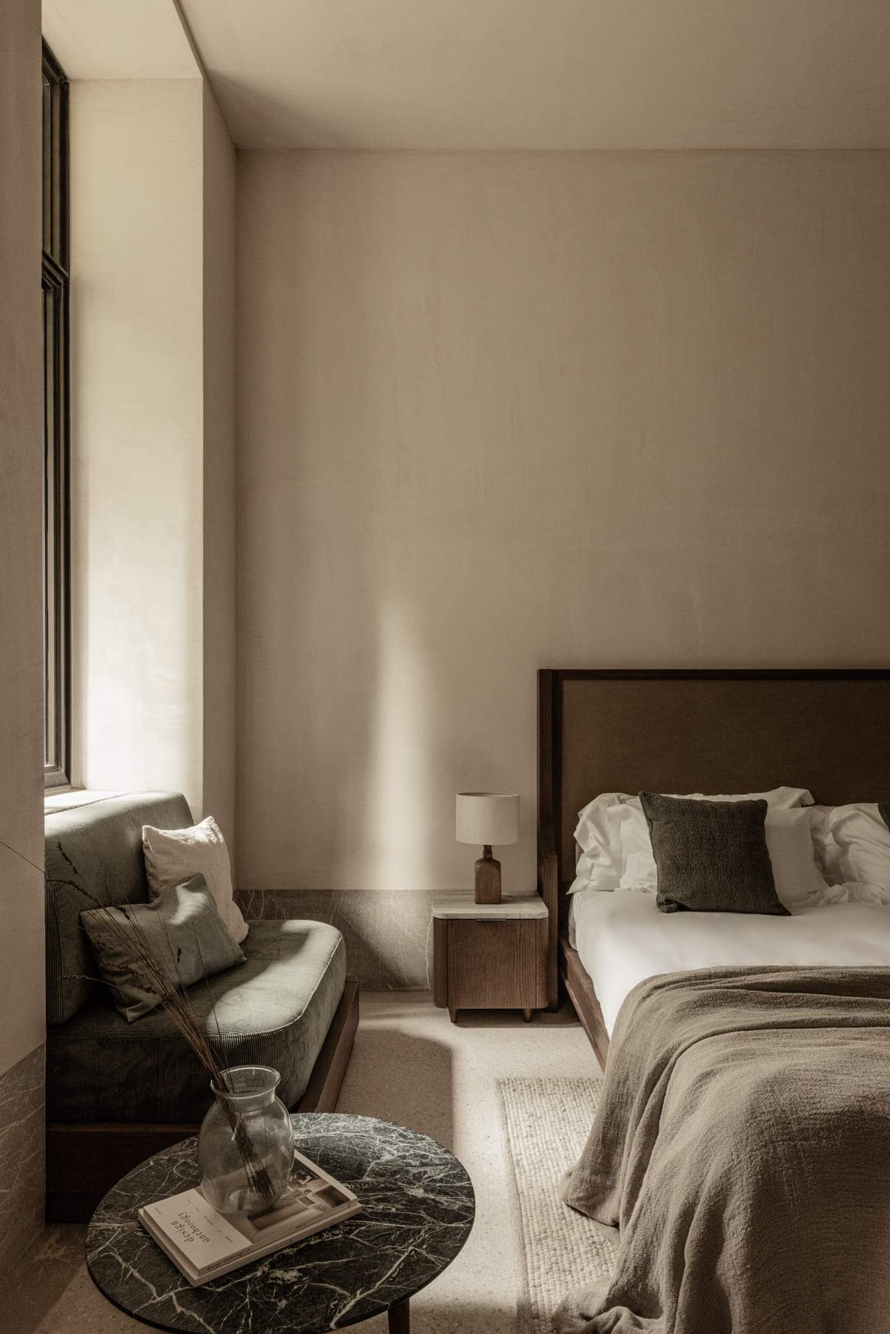 A bedroom with a bed and a couch.